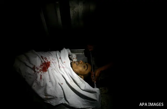 Palestinian relatives mourn over the body of Islamic Jihad militant Atia Moqat at El-shifa hospital after an Israeli air strike in Gaza City on 24 August 2011. Photo by Mahmud Nassar