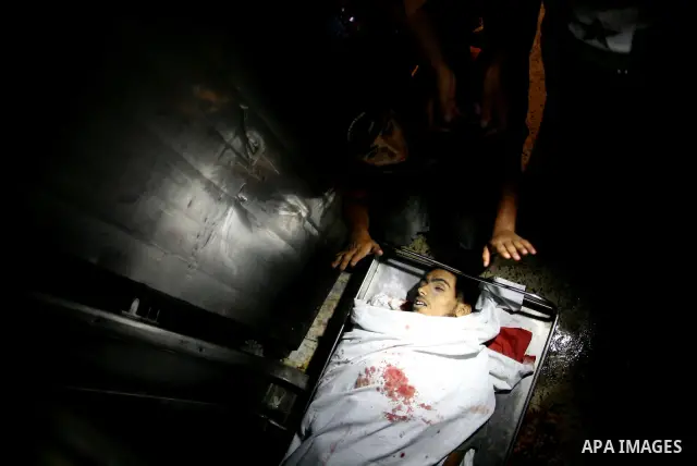 Palestinian relatives mourn over the body of Islamic Jihad militant Atia Moqat at El-shifa hospital after an Israeli air strike in Gaza City on 24 August 2011. Photo by Mahmud Nassar