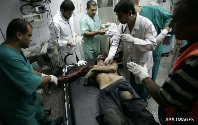 Palestinians doctors attend a wounded man at the Al Najar hospital following an Israeli air strike on a smuggling tunnel in Rafah, southern Gaza Strip, Thursday, Aug. 25, 2011. The Israeli military said its aircraft hit...