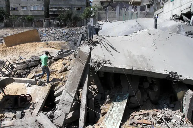 Palestinians inspect the grounds of a sporting club and the homes of some citizens that was destroyed by an overnight Israeli air raid in Beit Lahia, on August 25, 2011. A series of Israeli air strikes on Gaza over the p...