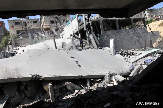Palestinians inspect the grounds of a sporting club and the homes of some citizens that was destroyed by an overnight Israeli air raid in Beit Lahia, on August 25, 2011. A series of Israeli air strikes on Gaza over the p...