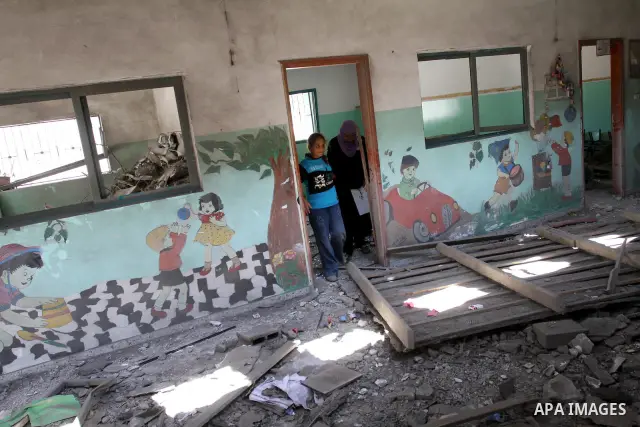 Palestinians inspect the damage in the kindergarten that was destroyed by an overnight Israeli air raid in Beit Lahia, on August 25, 2011. A series of Israeli air strikes on Gaza over the past 24 hours have killed five P...