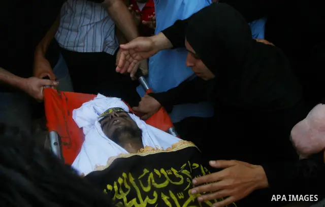 Palestinian relatives mourn over the body of Islamic Jihad militant Atteya Mqat during his funeral in Gaza City, on Aug. 25, 2011. Mqat was killed early Wednesday in Israeli airstrike in Gaza. Photo by Ashraf Amra