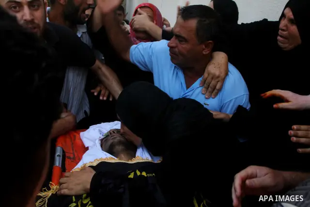 Palestinian relatives mourn over the body of Islamic Jihad militant Atteya Mqat during his funeral in Gaza City, on Aug. 25, 2011. Mqat was killed early Wednesday in Israeli airstrike in Gaza. Photo by Ashraf Amra
