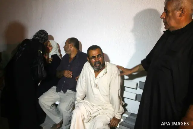 Palestinians mourn the body of Salem al-Arabed following an Israeli air strike killing two Islamic Jihad militants, at the main road in Jabaliya, northern Gaza Strip, Thursday, Aug. 25, 2011. Palestinian official said th...