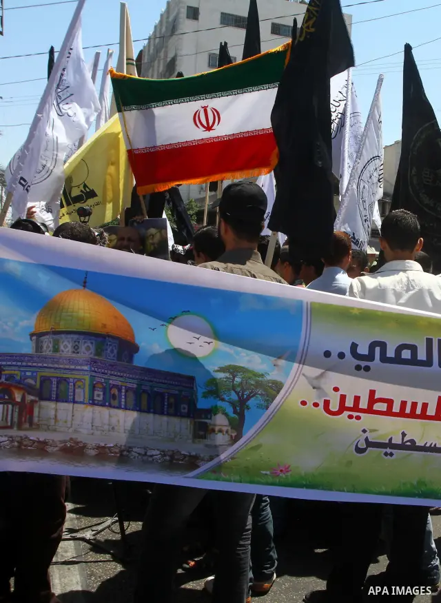 Palestinians wave with Iran's flag as they mark Quds Day or Jerusalem Day in Gaza city, Friday, Aug. 26, 2011. The late Iranian leader Ayatollah Khomeni declared the last Friday of the Islamic fasting month of Ramadan as...