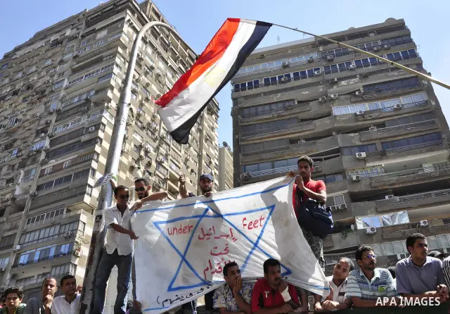 Egyptian protesters shout slogans against Israel during a protest in front of the Israeli Embassy in Cairo, Egypt, Friday, Aug.26, 2011. Hundreds of Egyptians protest the deaths of Egyptian security forces killed in a sh...