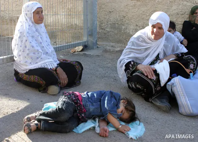Palestinian women wait to pass the checkpoint on their way to pray at the Al Aqsa Mosque, on the last Friday of the Muslim holy month of Ramadan, in the West Bank town of Bethlehem, early Friday, Aug. 26, 2011. Muslims a...