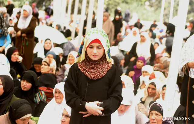 Palestinian Muslim women pray outside the Dome of the Rock mosque situated in the al-Aqsa mosque compound, Islam?s third most holy site, on August 26, 2011, in Israeli annexed east Jerusalem, on the last Friday of the Is...