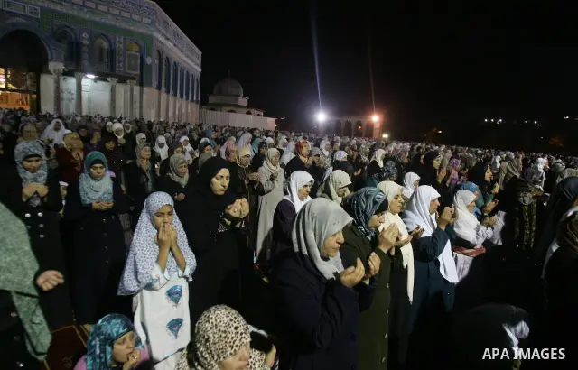 Palestinian muslim worshippers pray outside the Dome of the Rock in the Al-Aqsa Mosque compound in Jerusalem's Old City during the Islamic anniversary Lailat al-Qader, also known as the Night of Power, on August 27, 2011...