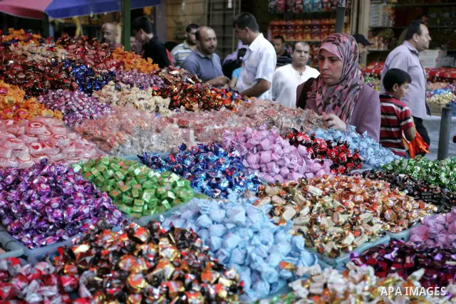 Palestinians buy sweets as Muslims shop ahead of the Eid al-Fitr celebrations in Rafah, southern Gaza Strip on Aug. 28, 2011. Muslims in the region will celebrate the Eid al-Fitr holiday starting with the sighting of the...