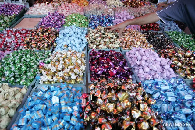 A Palestinian vendor sells sweets as Muslims shop ahead of the Eid al-Fitr celebrations in Rafah, southern Gaza Strip on Aug. 28, 2011. Muslims in the region will celebrate the Eid al-Fitr holiday starting with the sight...