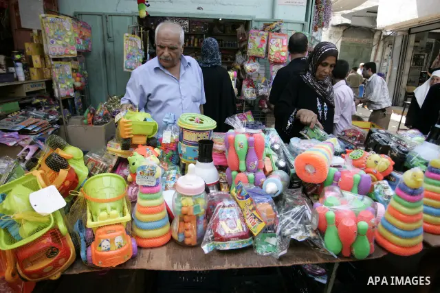 Palestinians buy plastic toys as Muslims shop ahead of the Eid al-Fitr celebrations in Rafah, southern Gaza Strip on Aug. 28, 2011. Muslims in the region will celebrate the Eid al-Fitr holiday starting with the sighting...