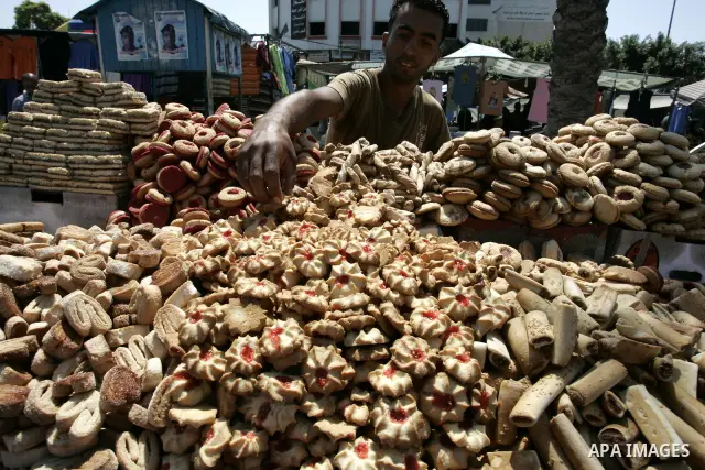 A Palestinian vendor sells sweets as Muslims shop ahead of the Eid al-Fitr celebrations in Rafah, southern Gaza Strip on Aug. 28, 2011. Muslims in the region will celebrate the Eid al-Fitr holiday starting with the sight...