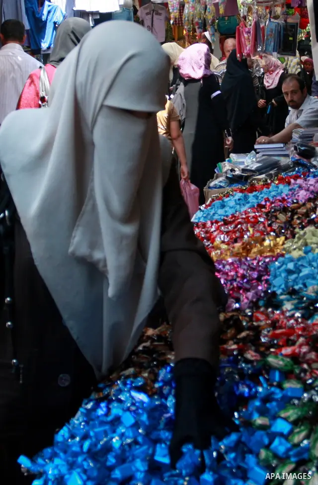 Palestinians buy sweets at a market, as Muslims shop ahead of the Eid al-Fitr celebrations in the West Bank city of Nablus on Aug. 28, 2011. Muslims in the region will celebrate the Eid Al-Fitr with the sighting of the n...