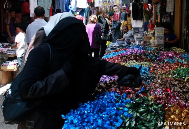 Palestinians buy sweets at a market, as Muslims shop ahead of the Eid al-Fitr celebrations in the West Bank city of Nablus on Aug. 28, 2011. Muslims in the region will celebrate the Eid Al-Fitr with the sighting of the n...