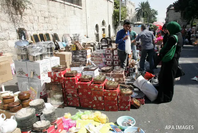 Palestinian vendors display their goods for sale during preparations for Eid aL-Fitr at the main market, in Jerusalem's old city 28 August 2011. Muslims throughout the world buy clothes and other popular items to prepare...