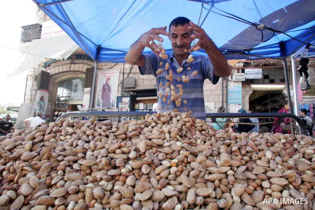A Palestinian vendor displays his goods for sale during preparations for Eid aL-Fitr at the main market, in Jerusalem's old city 28 August 2011. Muslims throughout the world buy clothes and other popular items to prepare...