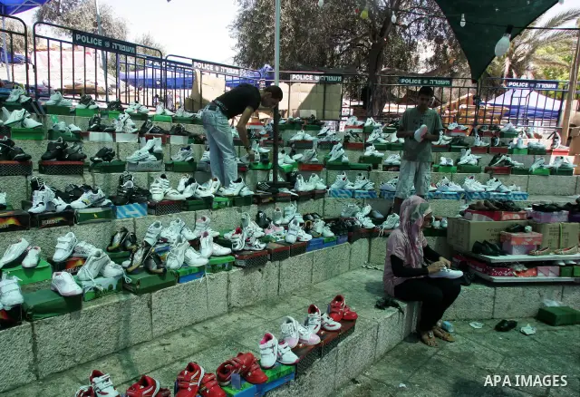 Palestinian vendors display their goods for sale during preparations for Eid aL-Fitr at the main market, in Jerusalem's old city 28 August 2011. Muslims throughout the world buy clothes and other popular items to prepare...