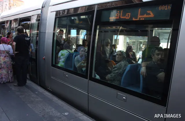 Palestinian and israeli Passengers ride a light rail train, Ten days after opened to the public in Jerusalem, on Aug. 29, 2011. The Jerusalem municipality said that a long-awaited light rail system is beginning operation...