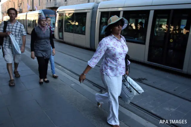 Palestinian and israeli Passengers ride a light rail train, Ten days after opened to the public in Jerusalem, on Aug. 29, 2011. The Jerusalem municipality said that a long-awaited light rail system is beginning operation...