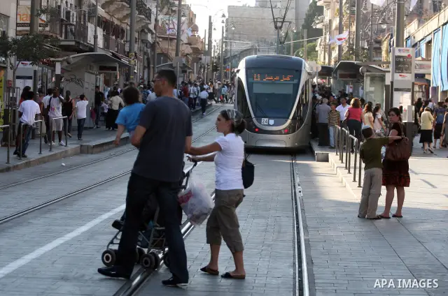 Palestinian and israeli Passengers ride a light rail train, Ten days after opened to the public in Jerusalem, on Aug. 29, 2011. The Jerusalem municipality said that a long-awaited light rail system is beginning operation...