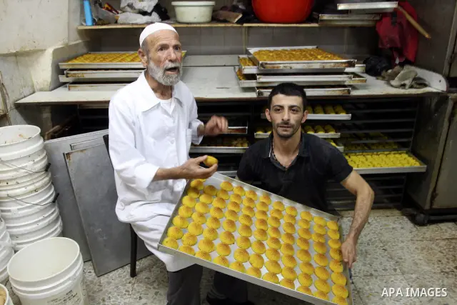 A Palestinian vendor prepares date-filled mini cakes traditional for the Eid al-Fitr, at his shop in the Old City in Jerusalem on Aug. 29, 2011. as Muslims the world over prepare to celebrate Eid al-Fitr, starting with t...