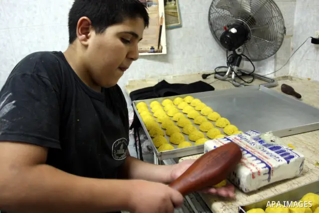 A Palestinian vendor prepares date-filled mini cakes traditional for the Eid al-Fitr, at his shop in the Old City in Jerusalem on Aug. 29, 2011. as Muslims the world over prepare to celebrate Eid al-Fitr, starting with t...