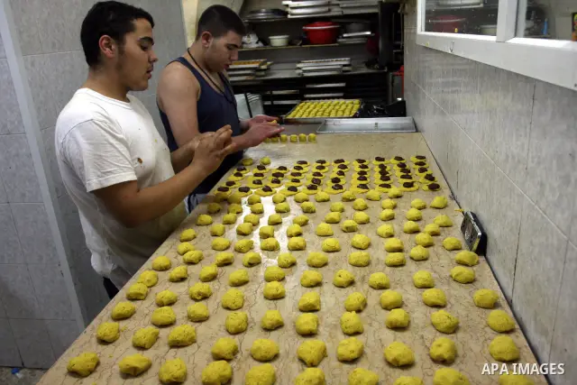 A Palestinian vendor prepares date-filled mini cakes traditional for the Eid al-Fitr, at his shop in the Old City in Jerusalem on Aug. 29, 2011. as Muslims the world over prepare to celebrate Eid al-Fitr, starting with t...