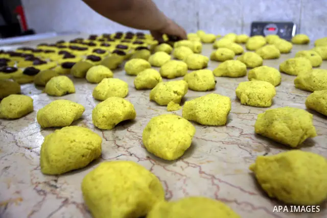 A Palestinian vendor prepares date-filled mini cakes traditional for the Eid al-Fitr, at his shop in the Old City in Jerusalem on Aug. 29, 2011. as Muslims the world over prepare to celebrate Eid al-Fitr, starting with t...