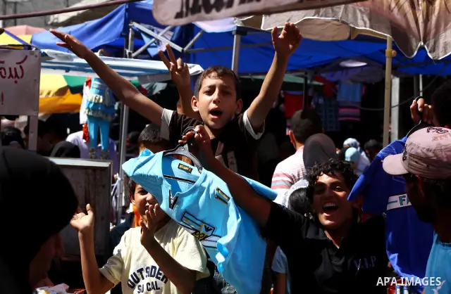 Palestinian vendors display their goods for sale during preparations for Eid aL-Fitr at the main market, in Gaza city 29 August 2011. Muslims throughout the world buy clothes, sweets and other popular items to prepare fo...