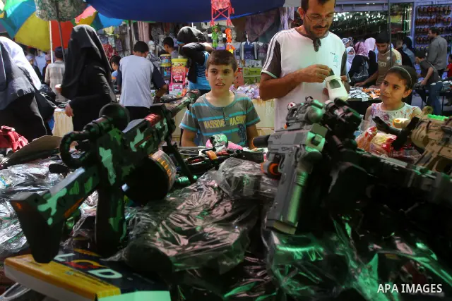 Palestinian vendors display their goods for sale during preparations for Eid aL-Fitr at the main market, in Gaza city 29 August 2011. Muslims throughout the world buy clothes, sweets and other popular items to prepare fo...