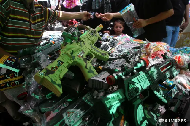 Palestinian vendors display their goods for sale during preparations for Eid aL-Fitr at the main market, in Gaza city 29 August 2011. Muslims throughout the world buy clothes, sweets and other popular items to prepare fo...