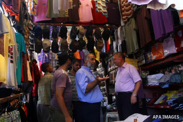 Palestinian vendors display their goods for sale during preparations for Eid aL-Fitr at the main market, in Gaza city 29 August 2011. Muslims throughout the world buy clothes, sweets and other popular items to prepare fo...