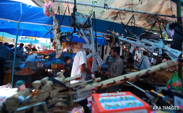 Palestinian vendors display their goods for sale during preparations for Eid aL-Fitr at the main market, in Gaza city 29 August 2011. Muslims throughout the world buy clothes, sweets and other popular items to prepare fo...