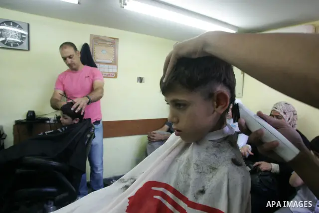 A Palestinian barber shaves for his customers ahead of Eid al-Fitr in Jerusalem's old city August 29, 2011. Eid al-Fitr marks the end of the Muslim holy month of Ramadan. Photo by Mahfouz Abu Turk
