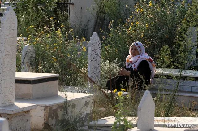 A Palestinians woman visits her relatives' graves in a cemetery during the first day of Eid al-Fitr in Gaza city on August 30, 2011. Eid al-Fitr marks the end of the Muslim holy month of Ramadan. Photo by Mohammed Asad