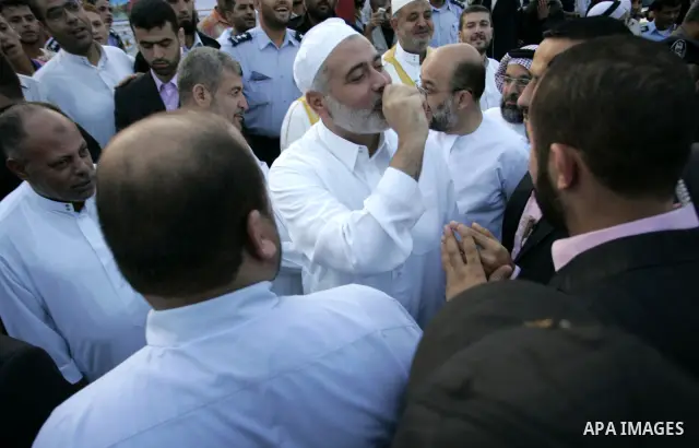 Ismail Haniya, Palestinian Prime Minister in the Gaza Strip, waves to the crowds after an open air morning prayer to celebrate Eid al-Fitr in Khan Yunis town the southern Gaza Strip on August 30, 2011. The Palestinian Te...
