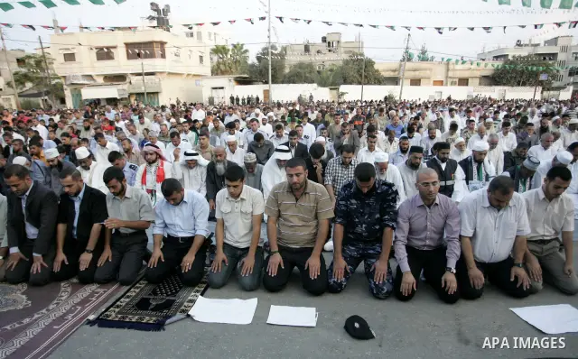 Palestinians attend an open air morning prayer to celebrate Eid al-Fitr in Khan Yunis town the southern Gaza Strip on August 30, 2011. The Palestinian Territories, along with other neighboring and Gulf states, announced...