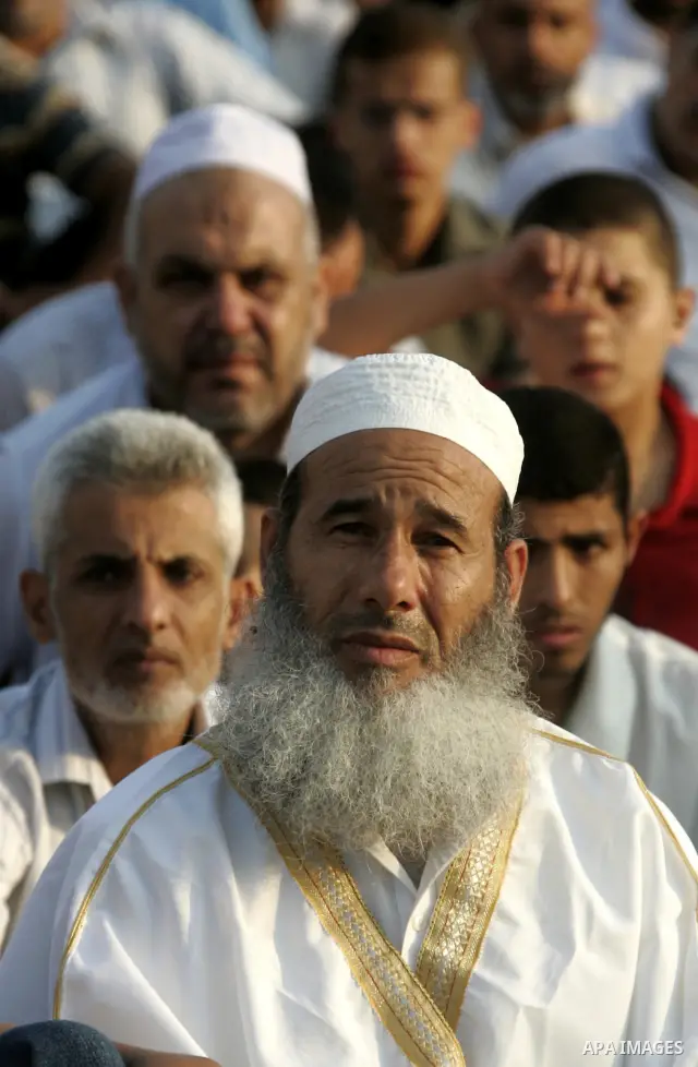 Palestinians attend an open air morning prayer to celebrate Eid al-Fitr in Khan Yunis town the southern Gaza Strip on August 30, 2011. The Palestinian Territories, along with other neighboring and Gulf states, announced...