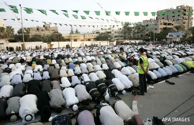 Palestinians attend an open air morning prayer to celebrate Eid al-Fitr in Khan Yunis town the southern Gaza Strip on August 30, 2011. The Palestinian Territories, along with other neighboring and Gulf states, announced...