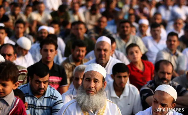 Palestinians attend an open air morning prayer to celebrate Eid al-Fitr in Khan Yunis town the southern Gaza Strip on August 30, 2011. The Palestinian Territories, along with other neighboring and Gulf states, announced...