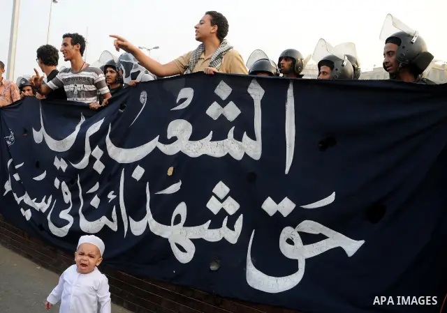 Police and military stand guard as Egyptian Muslims gather to pray, celebrating the start of the three-day feast known in Arabic Eid al-Fitr, which marks the end of the holy fasting month of Ramadan, in Tahrir Square, th...
