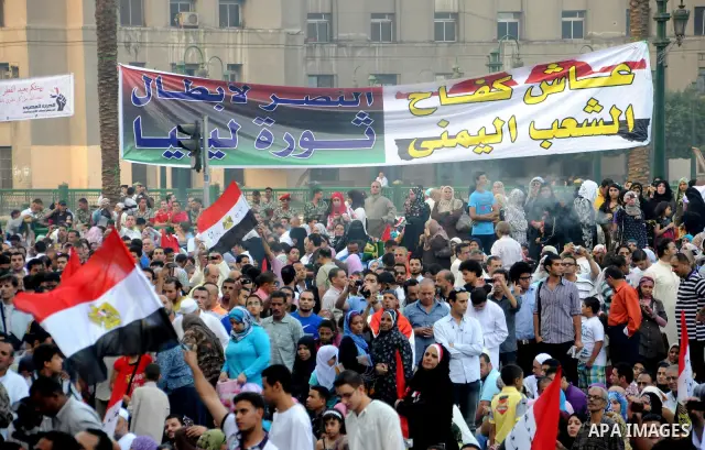 Egyptian Muslims gather to pray, celebrating the start of the three-day feast known in Arabic Eid al-Fitr, which marks the end of the holy fasting month of Ramadan, in Tahrir Square, the scene of mass demonstration which...
