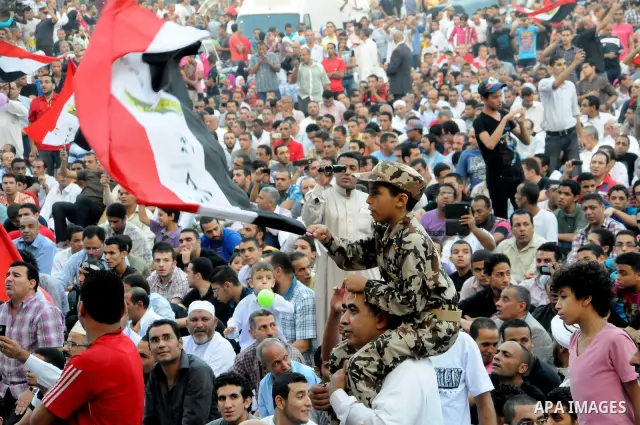 Egyptian Muslims gather to pray, celebrating the start of the three-day feast known in Arabic Eid al-Fitr, which marks the end of the holy fasting month of Ramadan, in Tahrir Square, the scene of mass demonstration which...