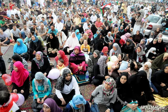 Egyptian Muslims gather to pray, celebrating the start of the three-day feast known in Arabic Eid al-Fitr, which marks the end of the holy fasting month of Ramadan, in Tahrir Square, the scene of mass demonstration which...