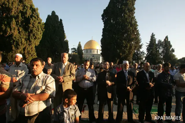 Palestinian men perform the morning Eid Al-Fitr prayer in front of the Dome of Rock at the Al-Aqsa Mosque compound, Islam's thrid most holy site, in Israeli annexed East Jerusalem, on August 30, 2011, marking the end of...