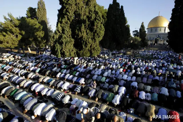 Palestinian men perform the morning Eid Al-Fitr prayer in front of the Dome of Rock at the Al-Aqsa Mosque compound, Islam's thrid most holy site, in Israeli annexed East Jerusalem, on August 30, 2011, marking the end of...