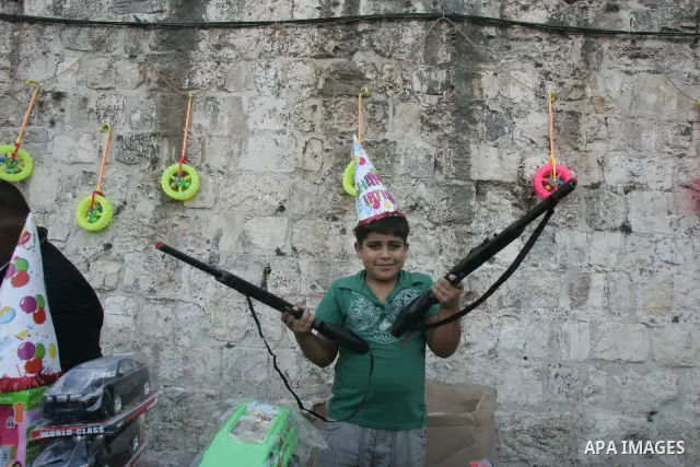 A Palestinian boy sells toys outside the Al-Aqsa Mosque compound, Islam's thrid most holy site, in Israeli annexed East Jerusalem, on August 30, 2011, marking the end of the fasting month of Ramadan. Photo by Mahfouz Abu...