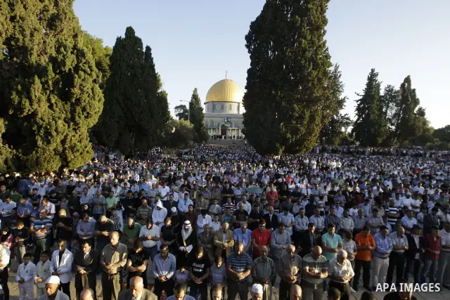 Palestinian men perform the morning Eid Al-Fitr prayer in front of the Dome of Rock at the Al-Aqsa Mosque compound, Islam's thrid most holy site, in Israeli annexed East Jerusalem, on August 30, 2011, marking the end of...